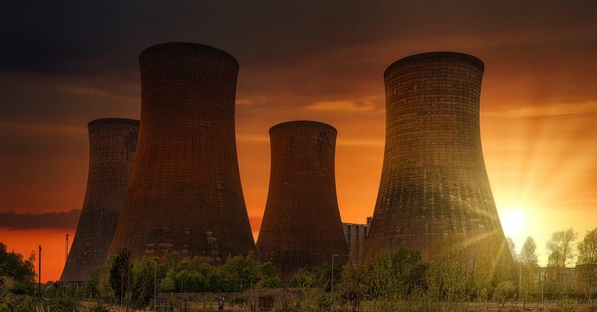 Does lead lining really work against a nuclear explosion? - Exterior of huge cooling towers located in contemporary atomic power plant against bright setting sun under dramatic dark sky