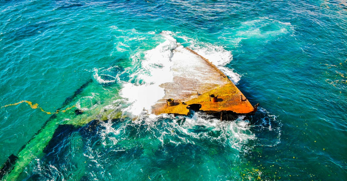 Does Mark get fuel to make water from the rocket that the other crew members had used to escape? - From above rusted grunge fragments of crashed boat lying in shallow sea and washed by clean green water