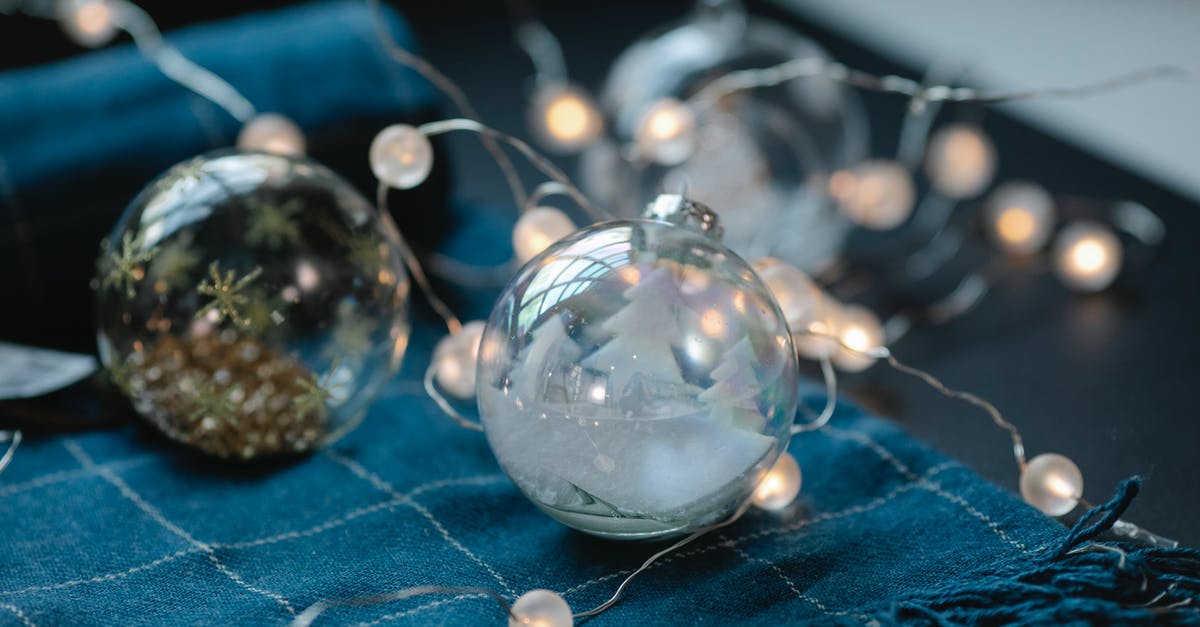 Does Natsu Dragneel retain his ability to utilize some of the non-dragonfire elemental magic he eats? - Transparent Christmas baubles filled with ornaments on table with blue warm scarf and glowing garland
