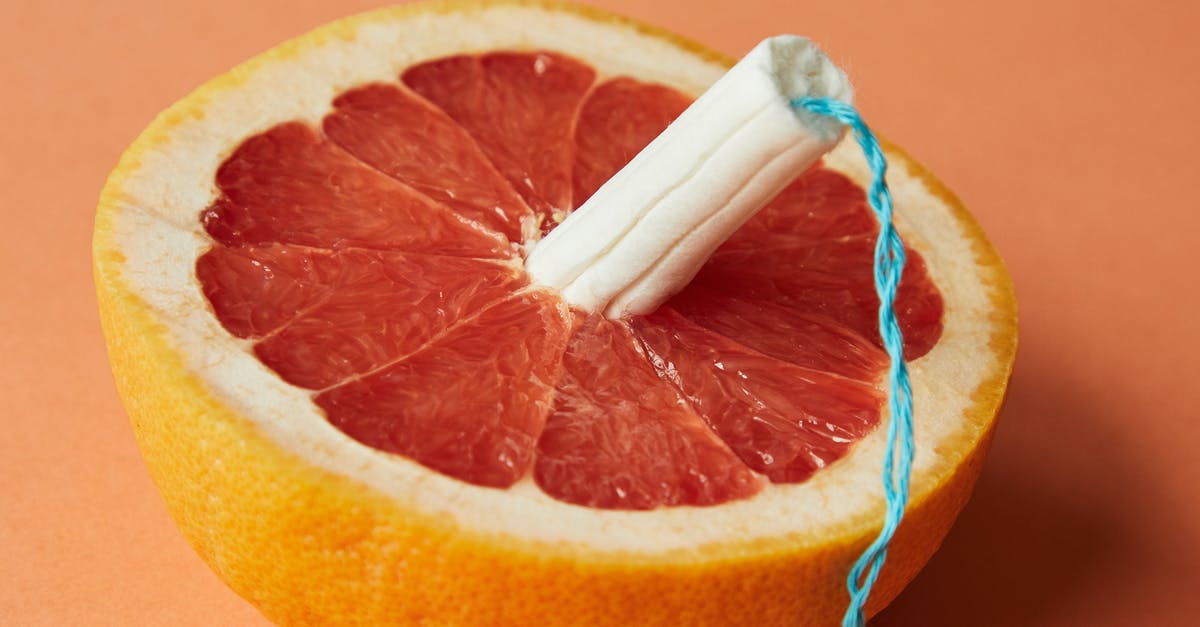 Does Sherlock Holmes (Elementary) use a Microsoft Surface™? - From above of half of sliced ripe grapefruit with tampon in center showing use of feminine product during menstruation
