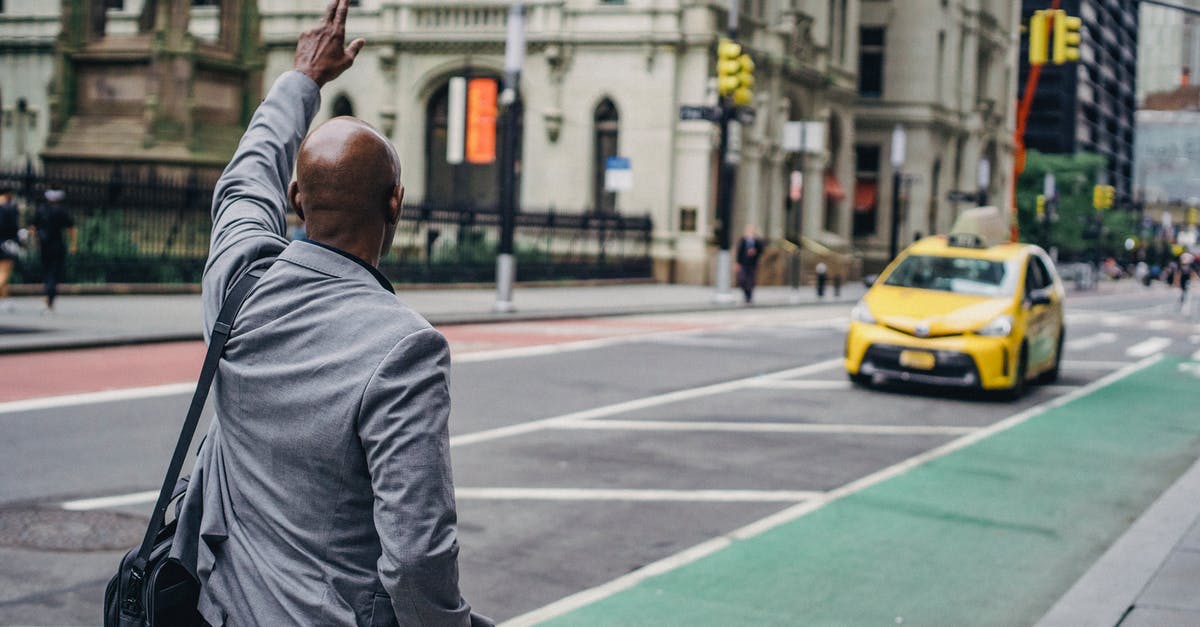 Does this method really work to catch rats? [closed] - Back view of anonymous African American male with hand up catching yellow cab on blurred background of road