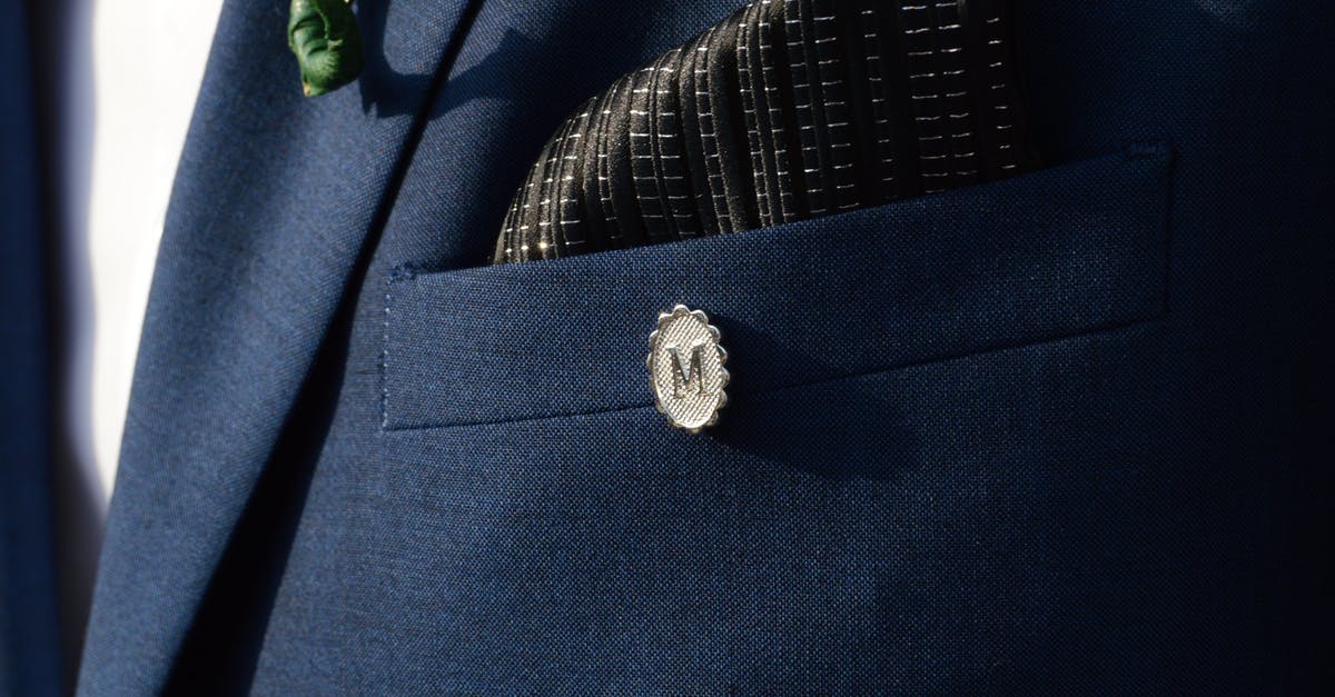 Does this pin Claudia wears have any significance? - Silver-colored M Lapel Pin