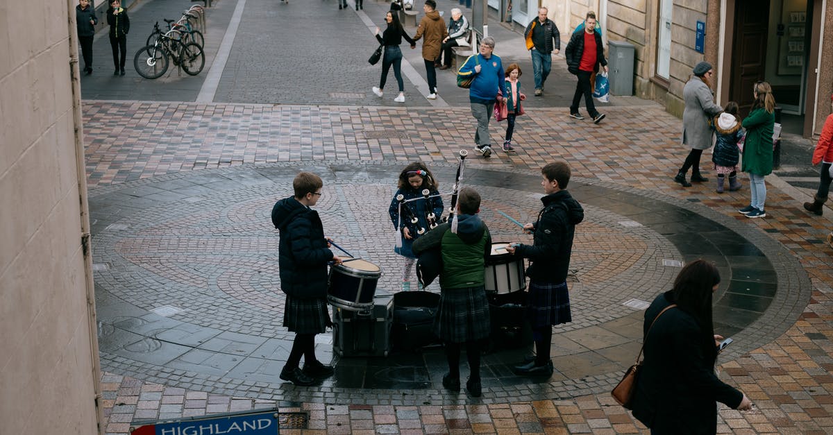Drummer is called 3 hours earlier on day 1 band rehearsals in Whiplash - Scottish teenage musicians wearing traditional clothes and playing drums and bagpipe on street on autumn day