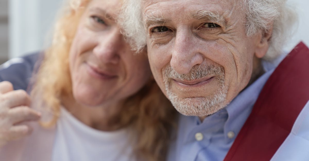 Elderly couple manipulate people in order to steal their bodies [closed] - Close-up of an Elderly Couple Draped with the American Flag