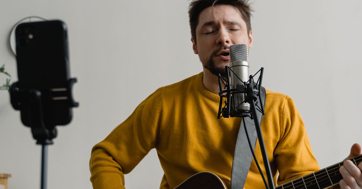 Expanse, S2E10: what song is Alex playing on the ship? [closed] - Photo of a Man in a Yellow Sweater Singing while His Eyes are Closed