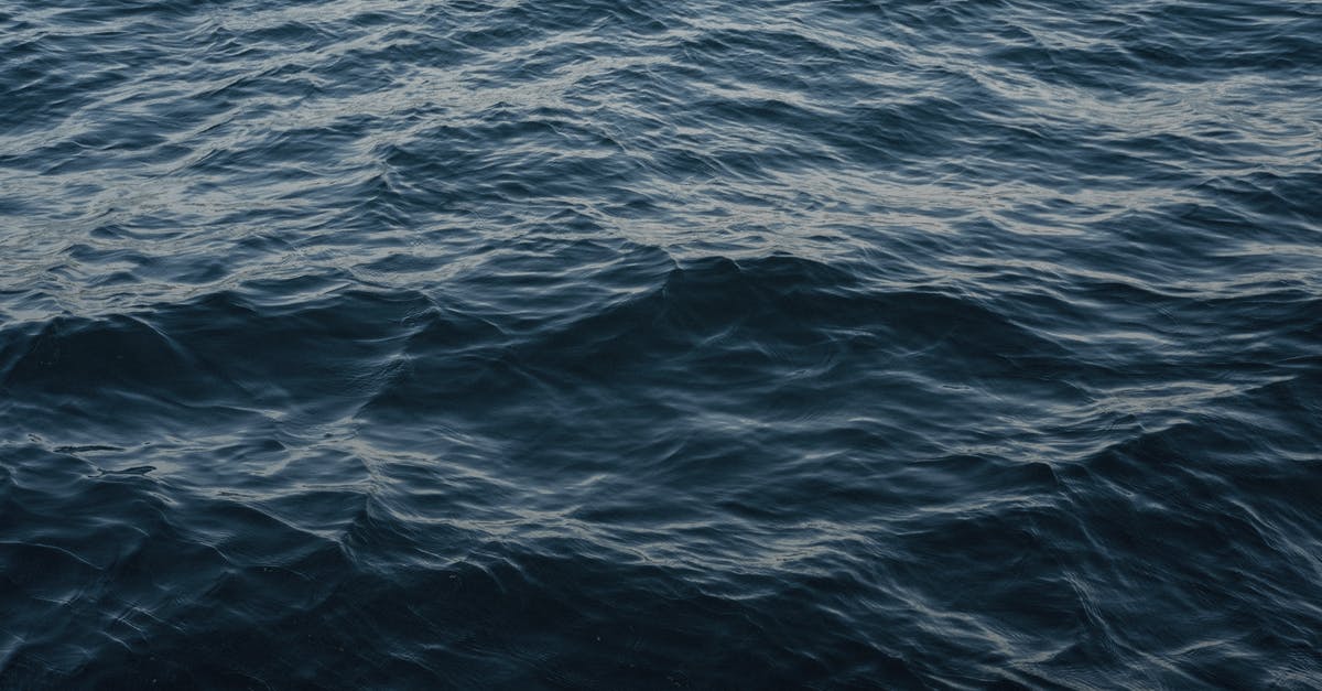 Final scene of Memento - From above of wavy dark blue ocean with ripples on surface in daytime