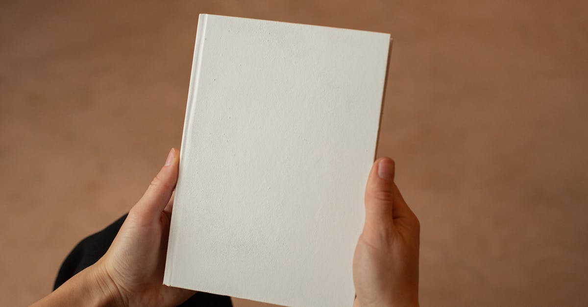Has a movie based on a novel ever had its own new novelisation? - Person holding hardcover book with blank cover