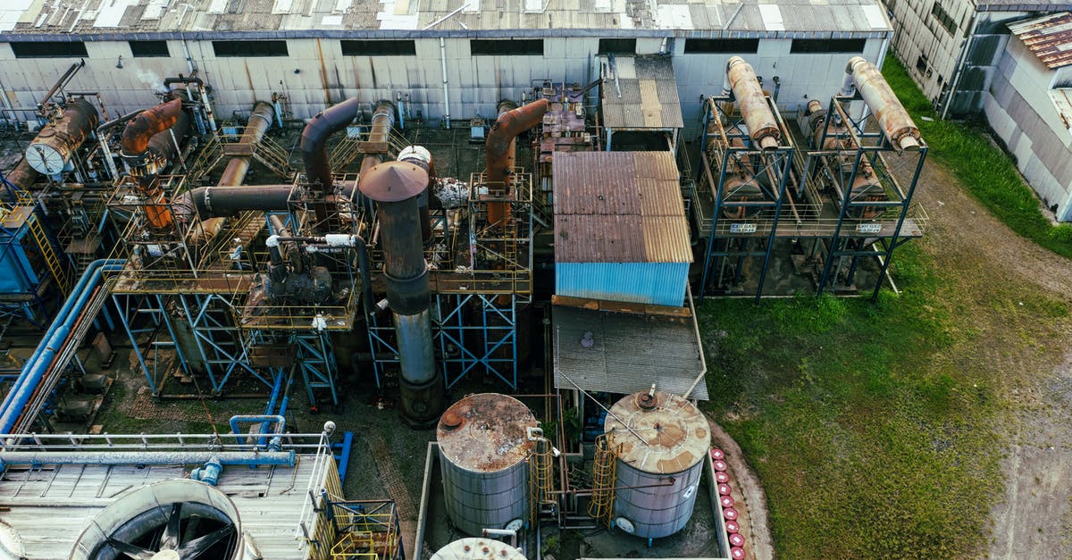 Has there been any proof that Storage Wars producers planted items? - Drone view of industrial area with barrels for petroleum products and pipes connected with warehouses