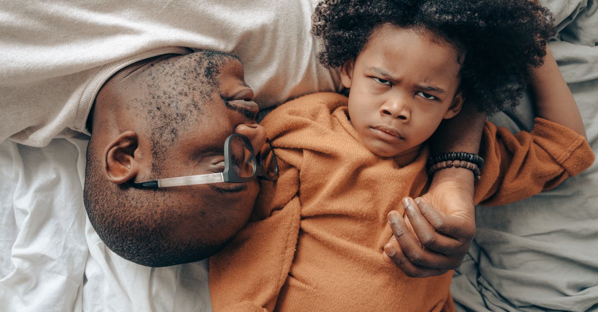 Help identifying TV show/movie with disabled kid and angry father [closed] - Top view of African American man in glasses lying near angry child in casual clothes while cuddling together in comfortable bedroom