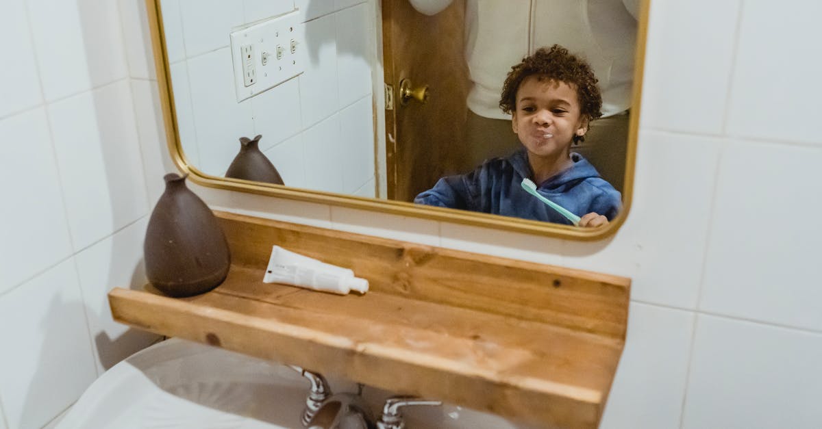 Horror movie, father rescuing son from world found behind a mirror [closed] - Black boy brushing teeth with unrecognizable father