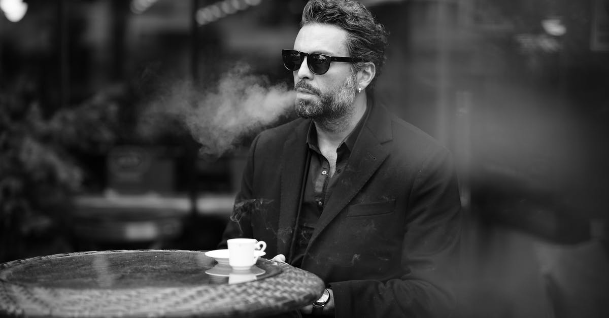 How accurate are the smoking and drinking habits of the characters on Mad Men? - Man in a Cafe Drinking Espresso and Smoking a Cigarette