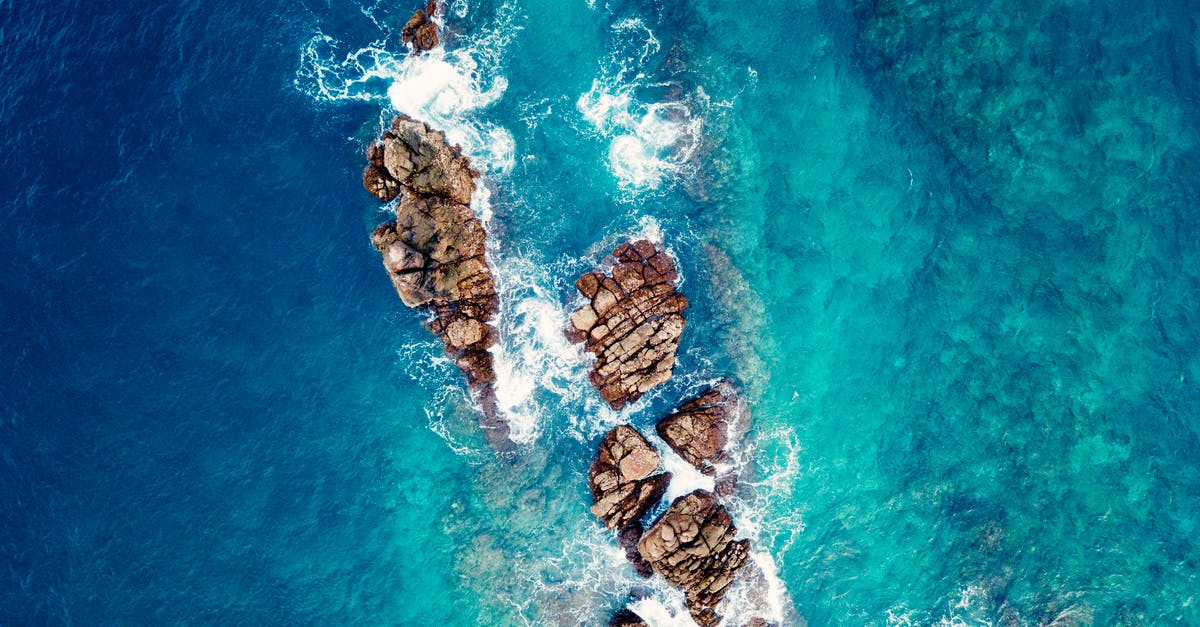 How are all the chief's stones on the one island in Moana? - Bird's Eye Photography of Rock Formations