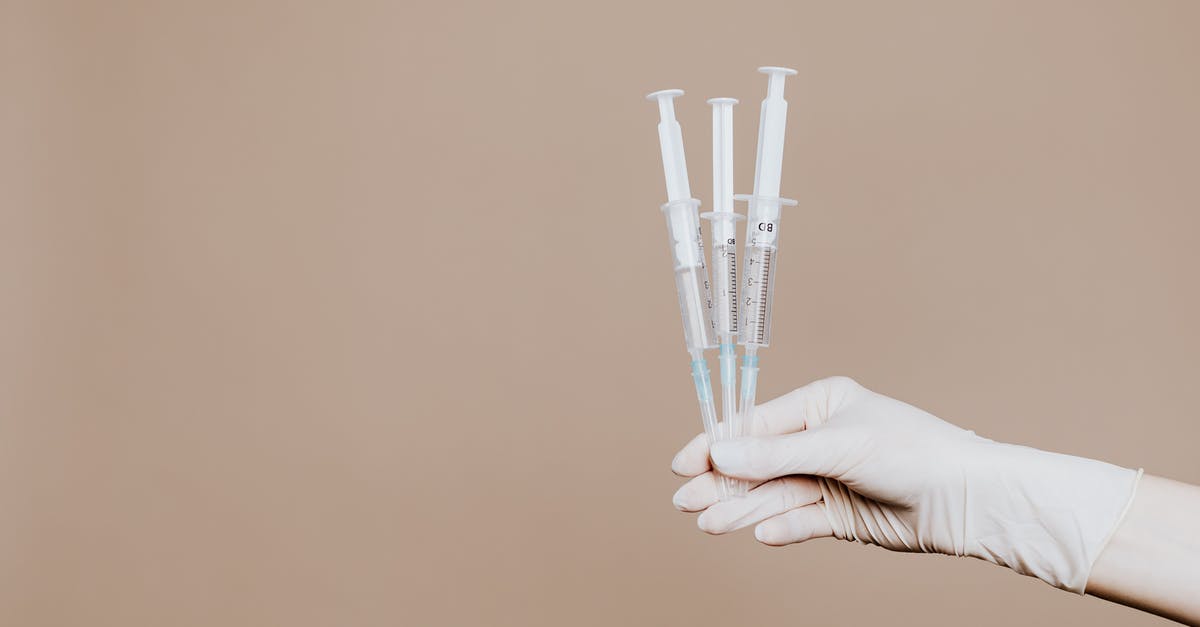 How are injections given without injuring actors? - Person Holding Three Syringes with Medicine