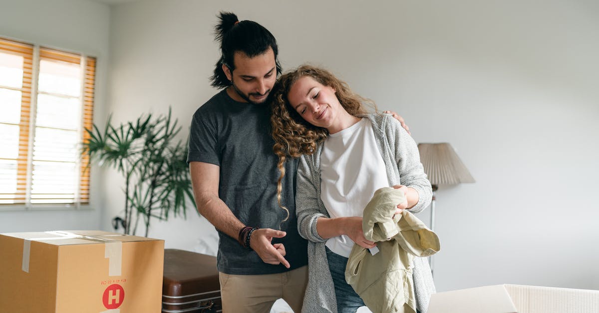 How are the measurements used by Nielsen evolving to meet new methods of content delivery and viewing? - Happy couple bonding and unpacking suitcase in new home