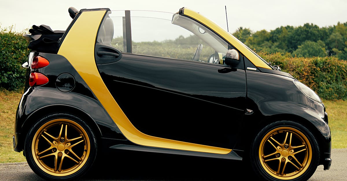 How Charlie and his team convert gold into car in such a short time span in Players? - Black and Yellow Smart Car on Focus Photography