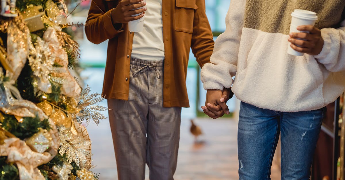 How close is Masters of Sex to the actual events? - Crop unrecognizable African American homosexual couple in stylish clothes holding hands while walking on city street decorated during Christmas holidays with takeaway coffee cups