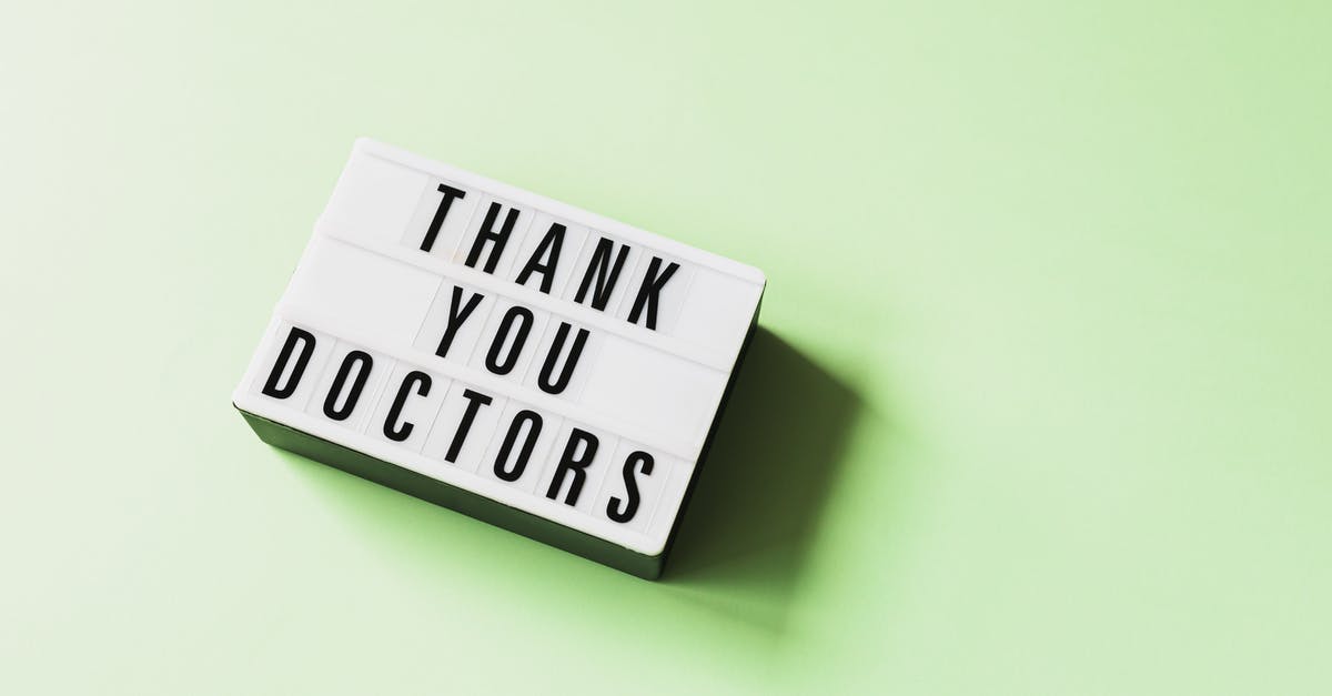 How come the present is not changed for the lab team? - From above of vintage light box with THANK YOU DOCTORS inscription placed on green surface