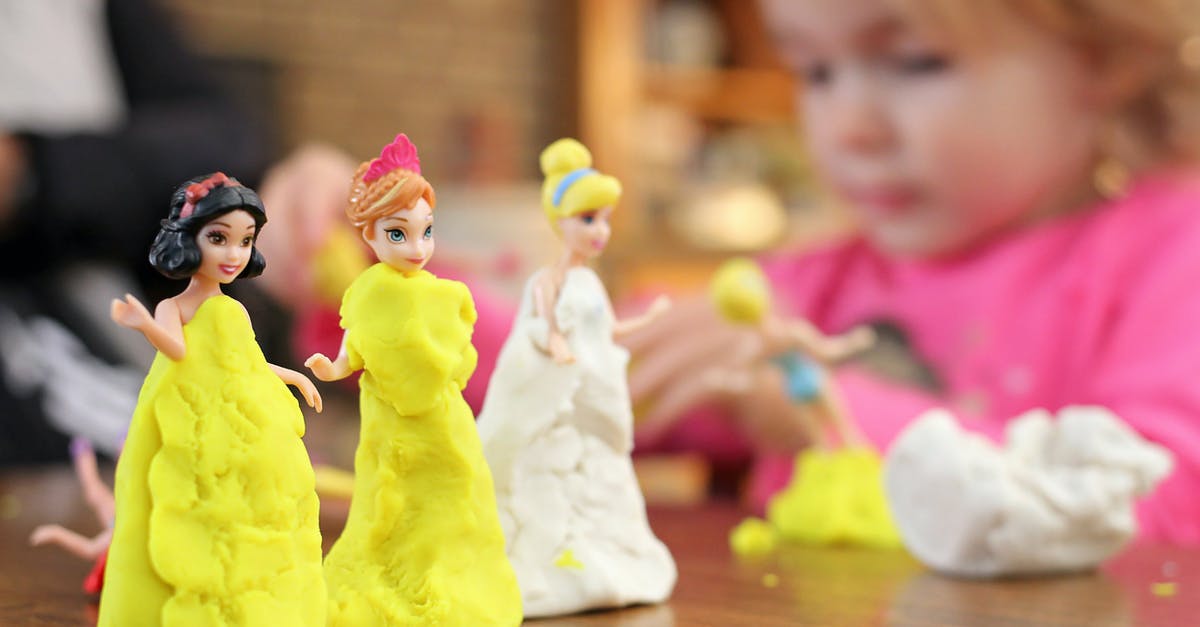How could Buzz come to know about Al's Toy Barn? - Selective Focus Photography of Three Disney Princesses Figurines on Brown Surface