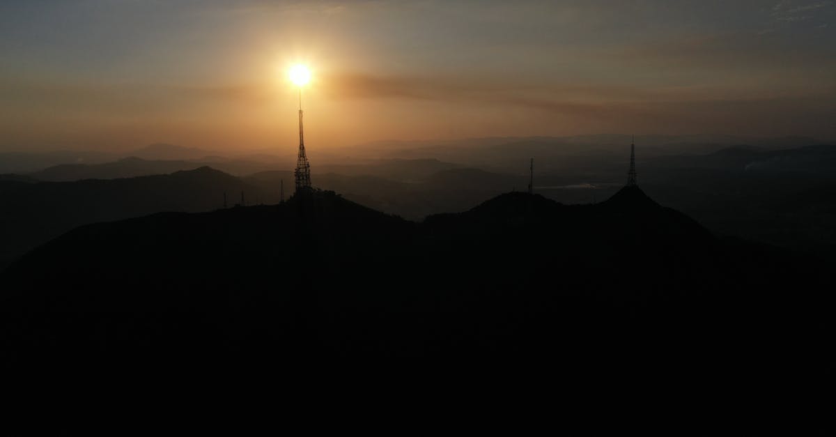 How could Ryan land in New York in early morning? - Sunrise over hilly terrain with telecommunication towers