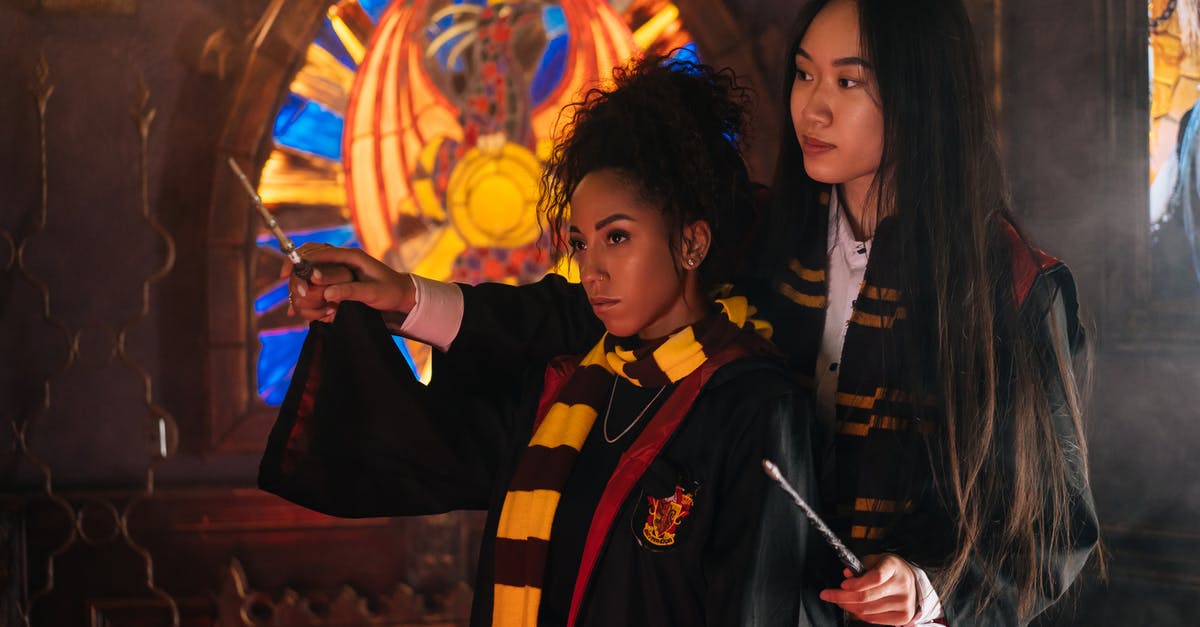 How crucial are the wizard wands in Harry Potter? - A Woman Teaching a Student while Holding a Wand