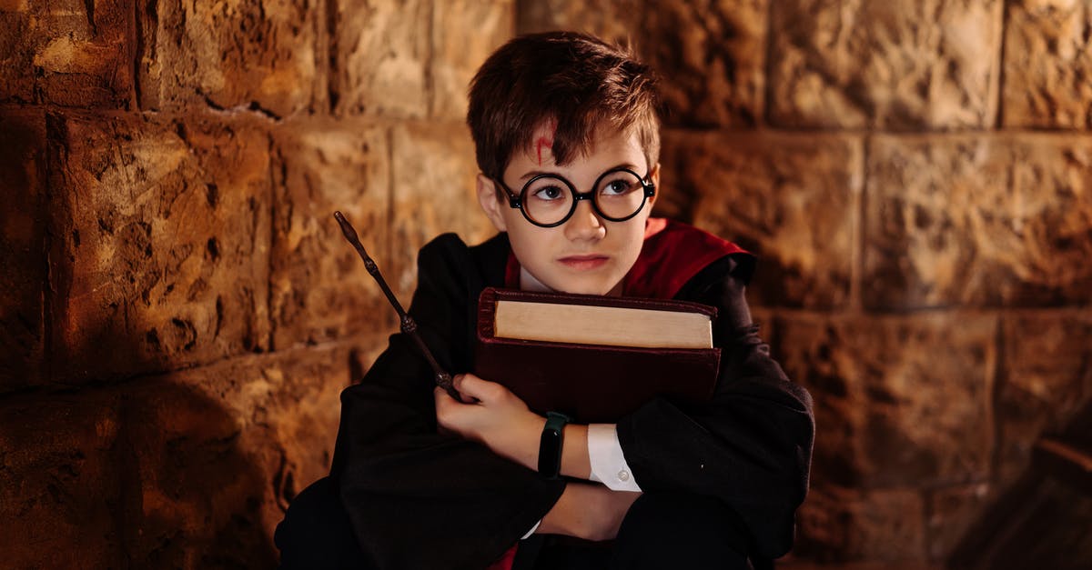 How crucial are the wizard wands in Harry Potter? - Boy in Black Framed Eyeglasses Holding a Book