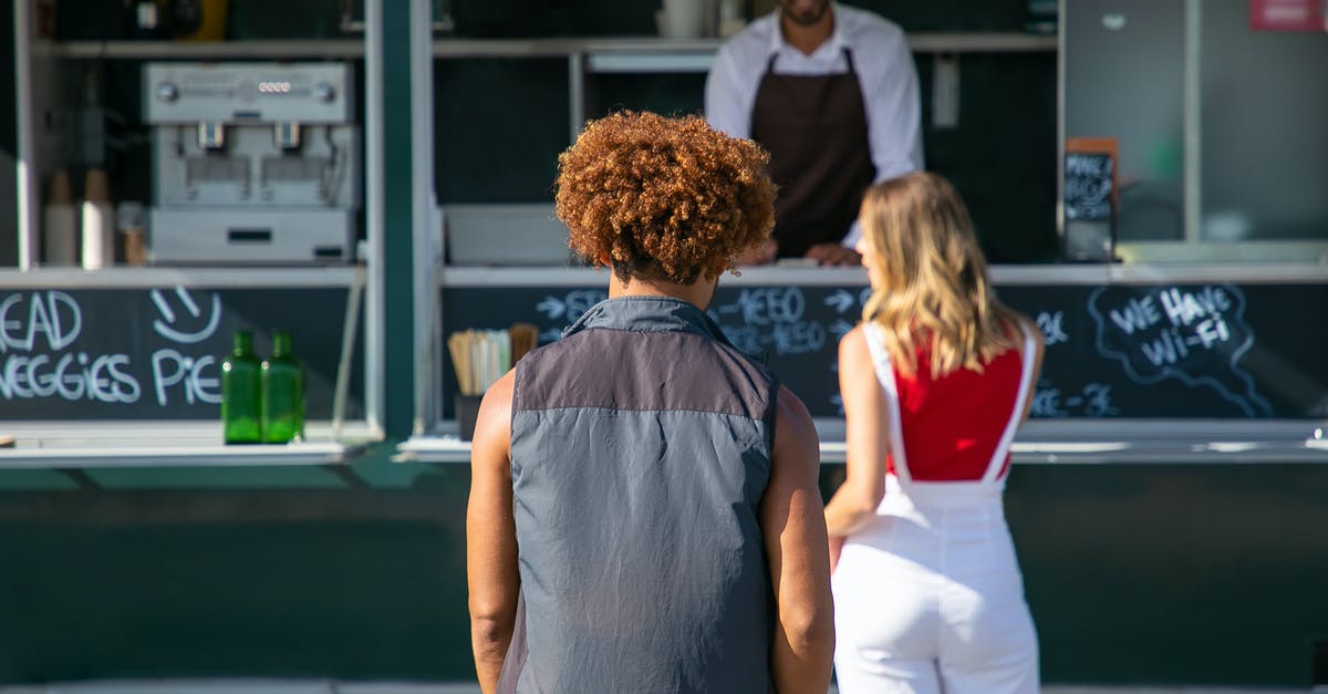 How did Alex get the job at a fast food restaraunt with no ID? - Back view of diverse clients standing near street food truck and choosing lunch