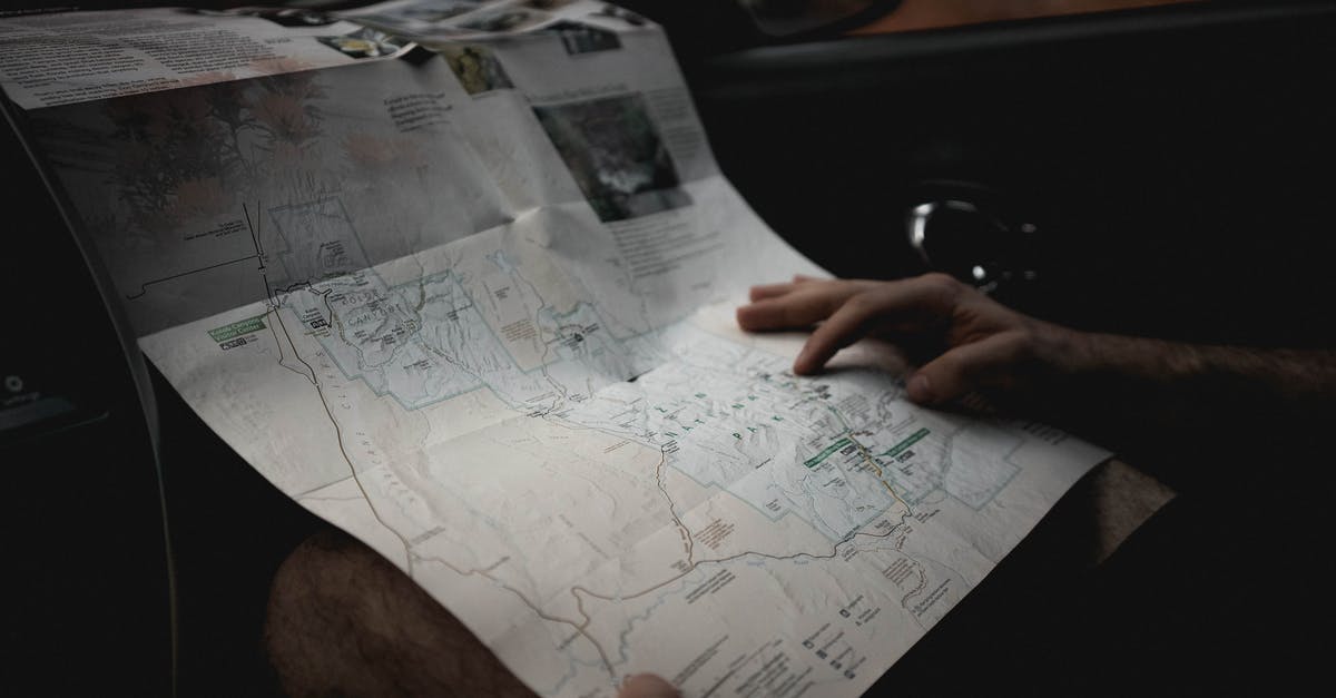 How did Bryan find his ex-wife in Taken 2? - Crop man with map in automobile