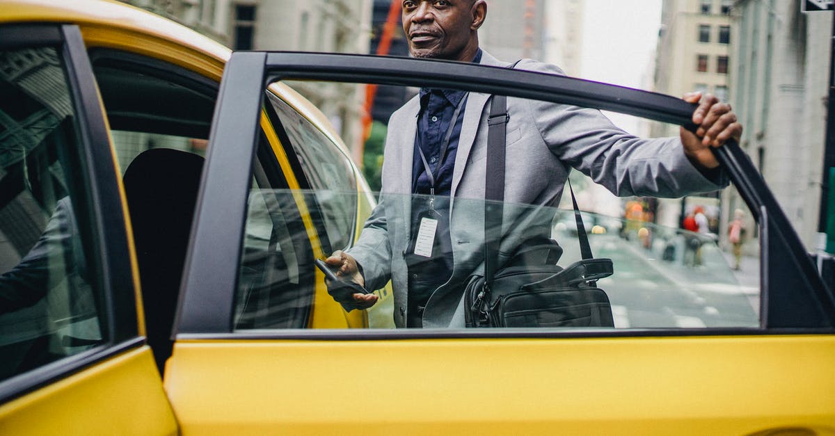 How did Butch manage to open the cab door with his boxing gloves on? - Black businessman opening taxi door in modern city