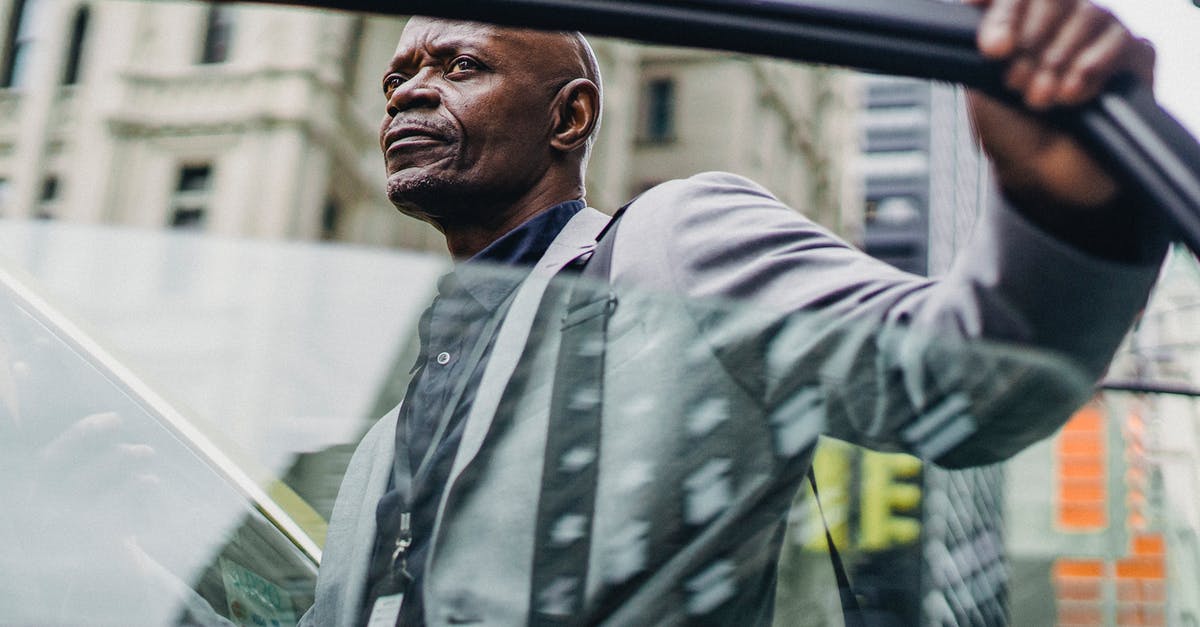 How did Butch manage to open the cab door with his boxing gloves on? - Serious black businessman opening taxi door