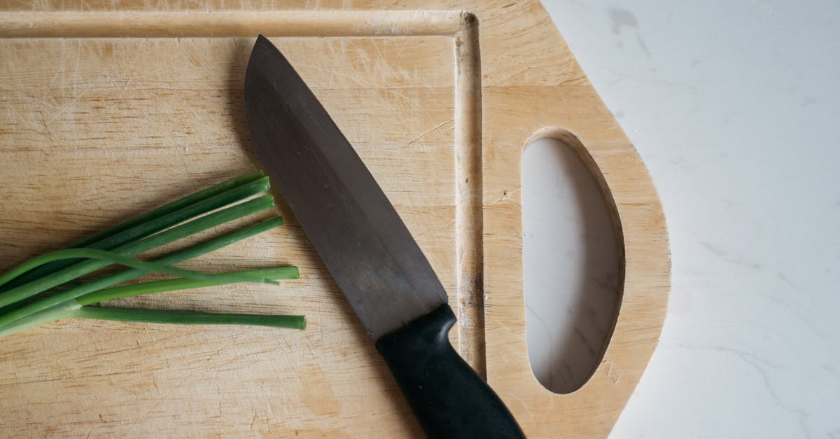 How did David's Knife hurt Arthur? - Black Handled Knife on Brown Wooden Chopping Board