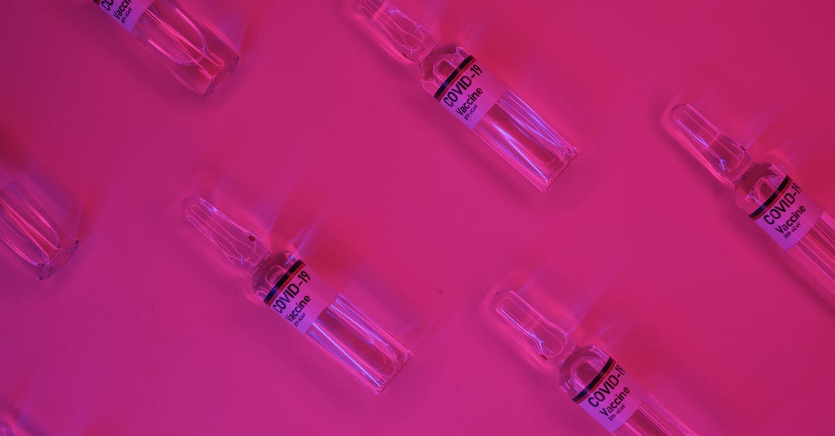 How did Doctor Strange repeat the scene where he made the deal with Dormammu? - Top view of set of glass ampoules with COVID 19 vaccine arranged on bright pink surface under neon illumination