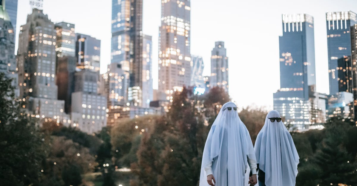 How did Dr. Evil build his moonbase without anyone knowing about it? - Unrecognizable couple in ghost costumes in city