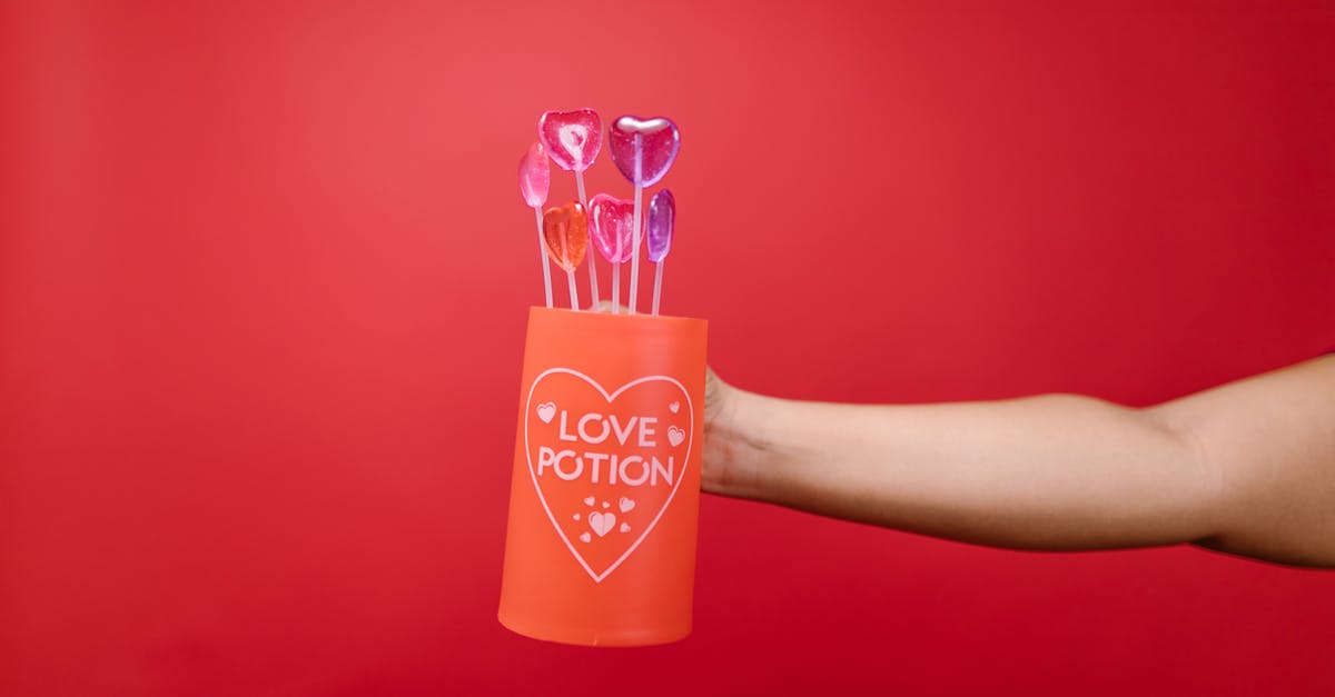 How did Jimmy retrieve Clyde's arm? - Person Holding Red Mug With Heart Shaped Lollipops