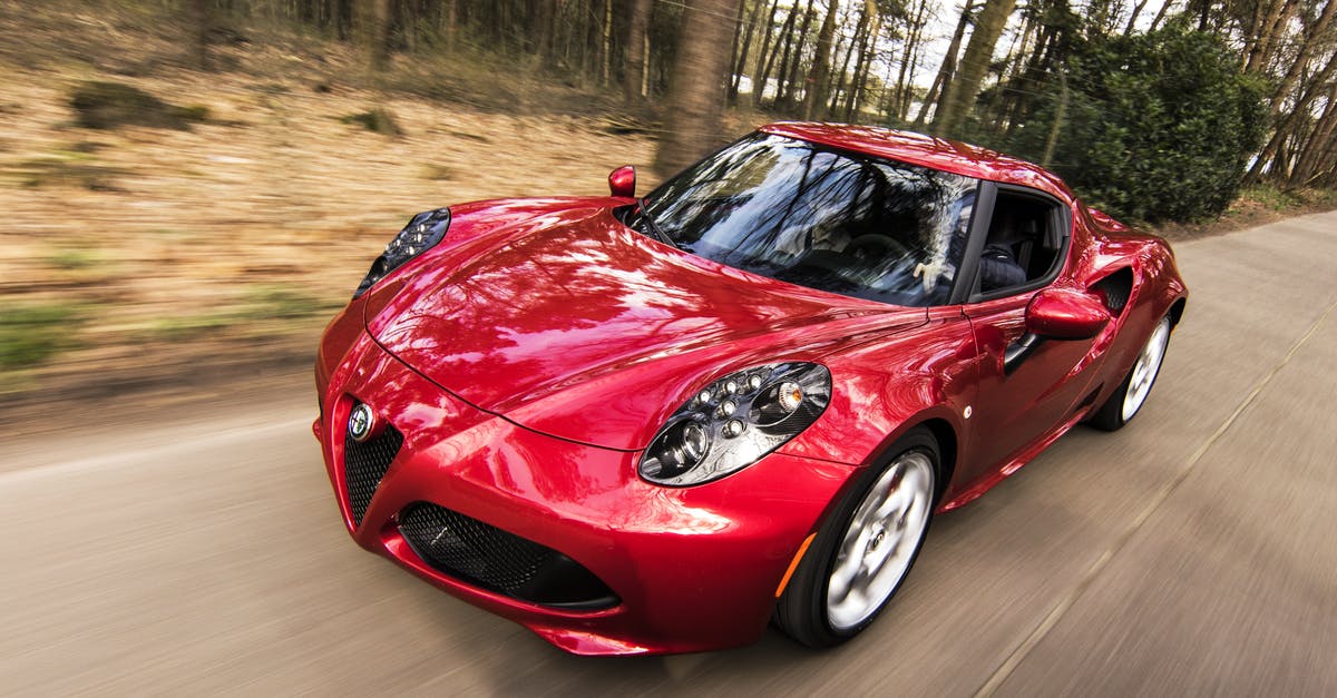 How did launched vehicles match speed of slingshot vehicle? - Red Alfa Romeo C4 on Road Near Trees