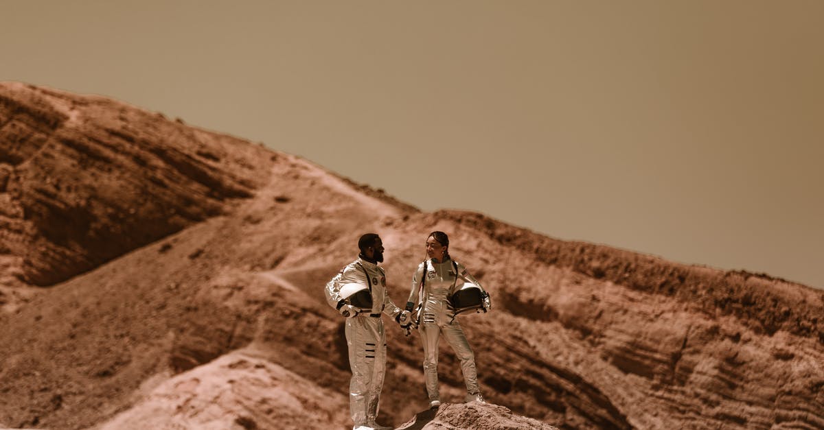 How did NASA astronauts launch the pod from Mars, though they were at millions of Kilometres away? - A Couple in Space Suit Standing on a Rock Formations while Holding Hands