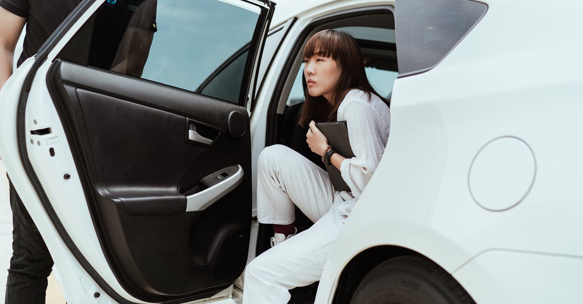 How did pied piper get uploaded to smart fridges - Thoughtful unemotional Asian female in stylish white clothes with modern tablet getting off white car
