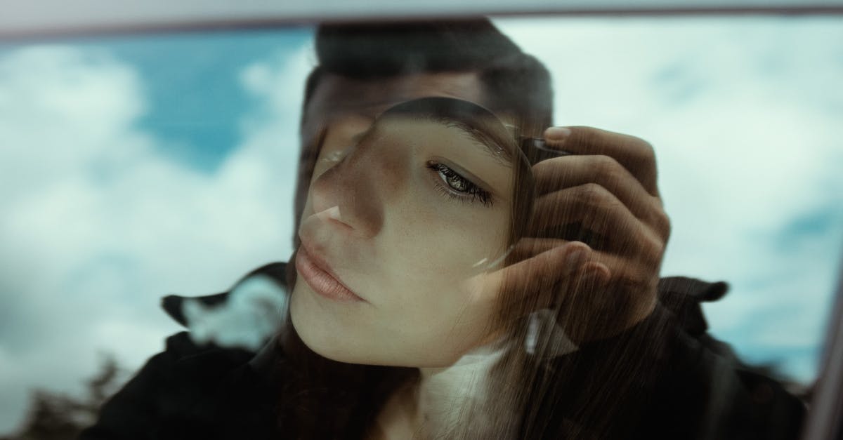 How did the camera pass through the window (and then back out) in The Book of Eli? - Unrecognizable man taking photo of pensive young female sitting in car and looking through window