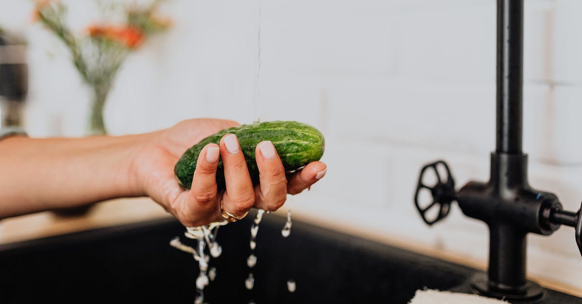 How did the cucumber get detected at the airport? - Woman Washing Cucumber under Tap Water 