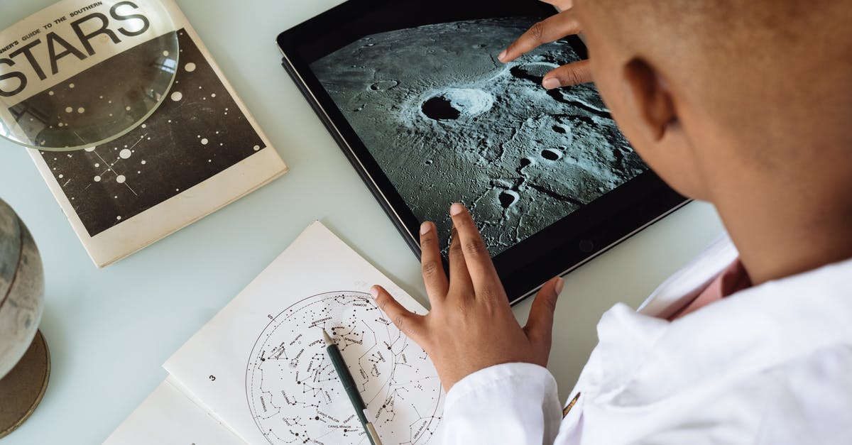 How did the information from the black hole do this? [duplicate] - Crop African American student studying craters of moon on tablet at observatory