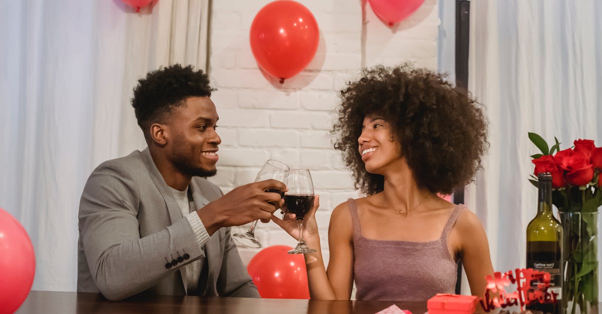 How did the other Brainiac 5 know about the bottle? - Cheerful black couple with wine glasses