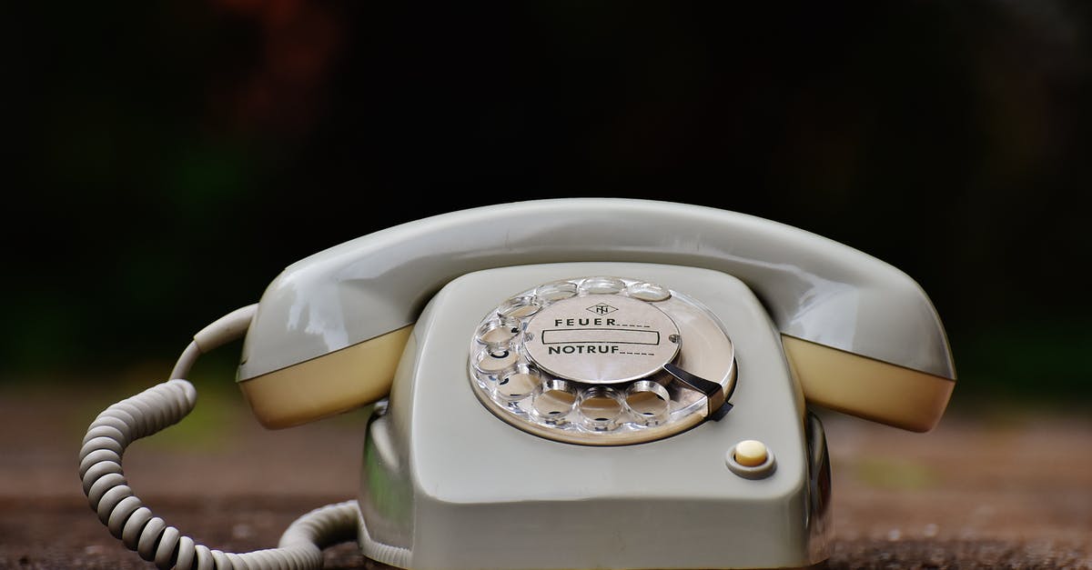 How did the phone ring when receiver was being held by Morrie? - Gray Rotary Telephone on Brown Surface