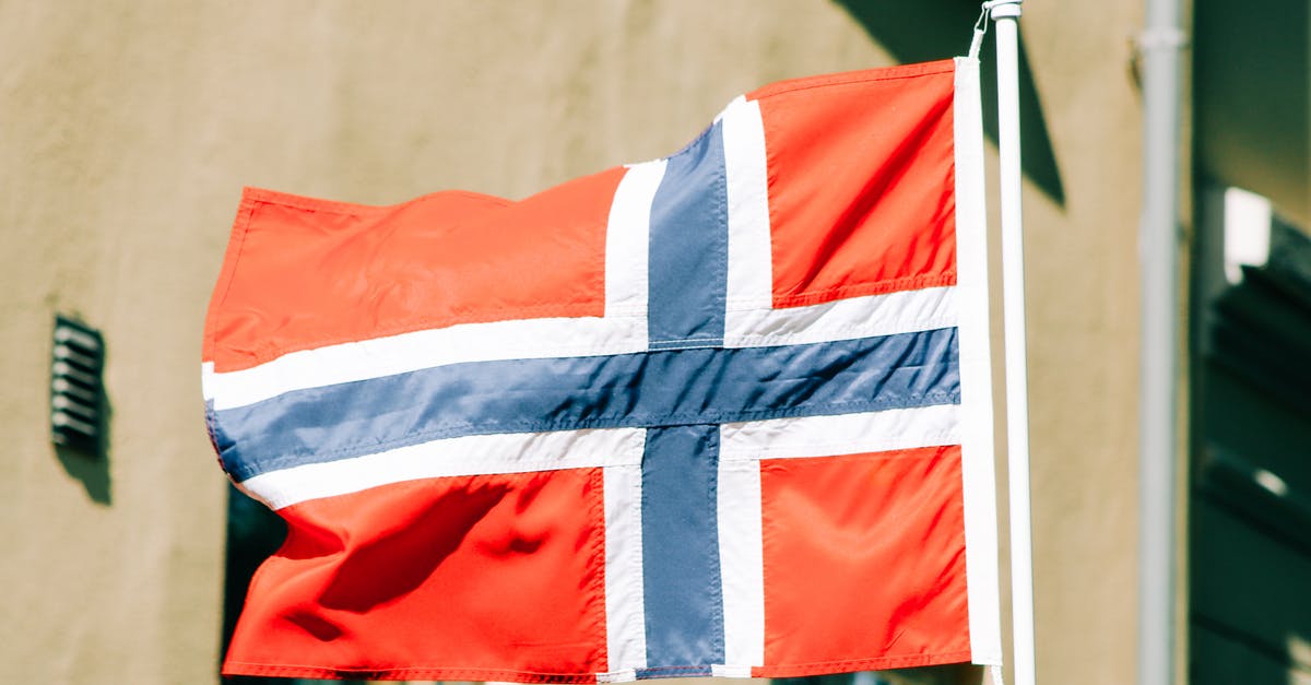 How did the Tesseract end up in Norway during the events of Captain America? - Flag of Norway with white blue and red stripes waving on flagstaff against building