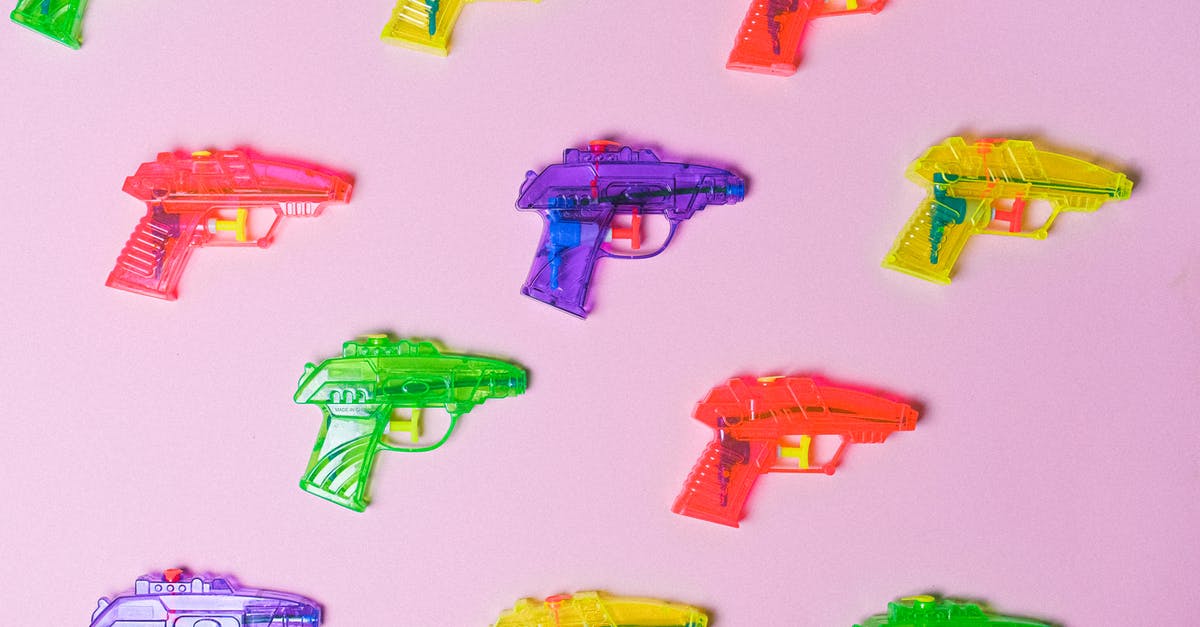 How did they make these gun sound effects from the 1970's? - Top view of various multicolored toys for fight arranged on pink background as representation of game