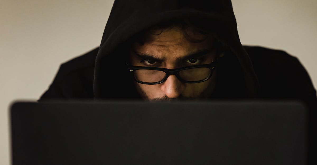 How did this violation of the "Penn & Teller: Fool Us" rules get past the screening process? - Serious young male programmer wearing black hoodie browsing netbook and hacking software in studio