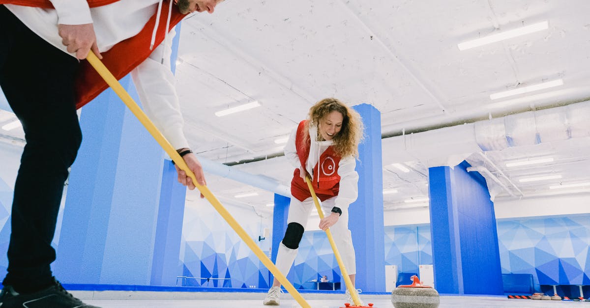 How did Thor know the Power stone was in play? - Sportswoman and sportsman playing curling on light ice rink