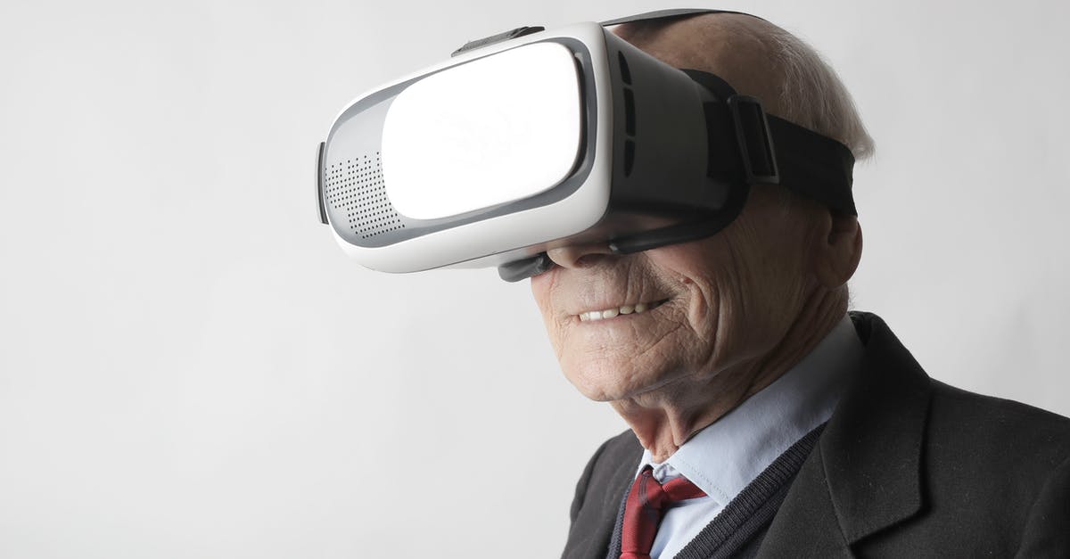 How did V.I.K.I. (Virtual Interactive Kinetic Intelligence) become self aware? - Smiling elderly gentleman wearing classy suit experiencing virtual reality while using modern headset on white background