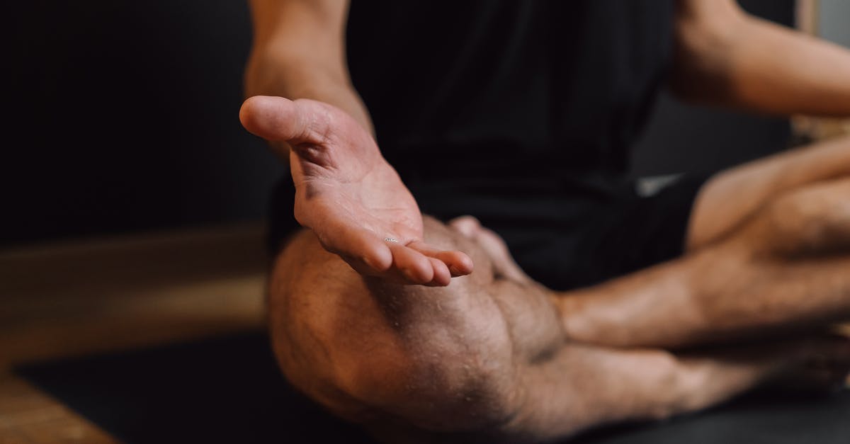 How did Voldemort know he could access Harry's mind but not realise this was because part of his soul was latched onto him? - Crop unrecognizable barefoot male sitting with crossed legs on sports mat during stress relief meditation session