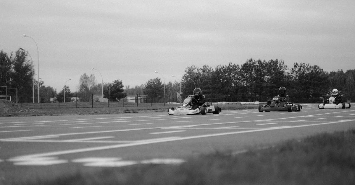 How did Whiplash know that Tony Stark is going to the racing track? - Monochrome Shot of Go Kart Racers in a Competition 