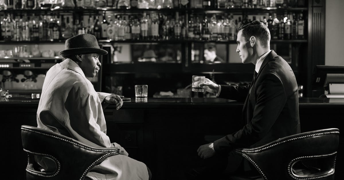 How do actors make eye contact with CGI characters? - Monochrome Photo of Men Sitting in Front of Bar Counter