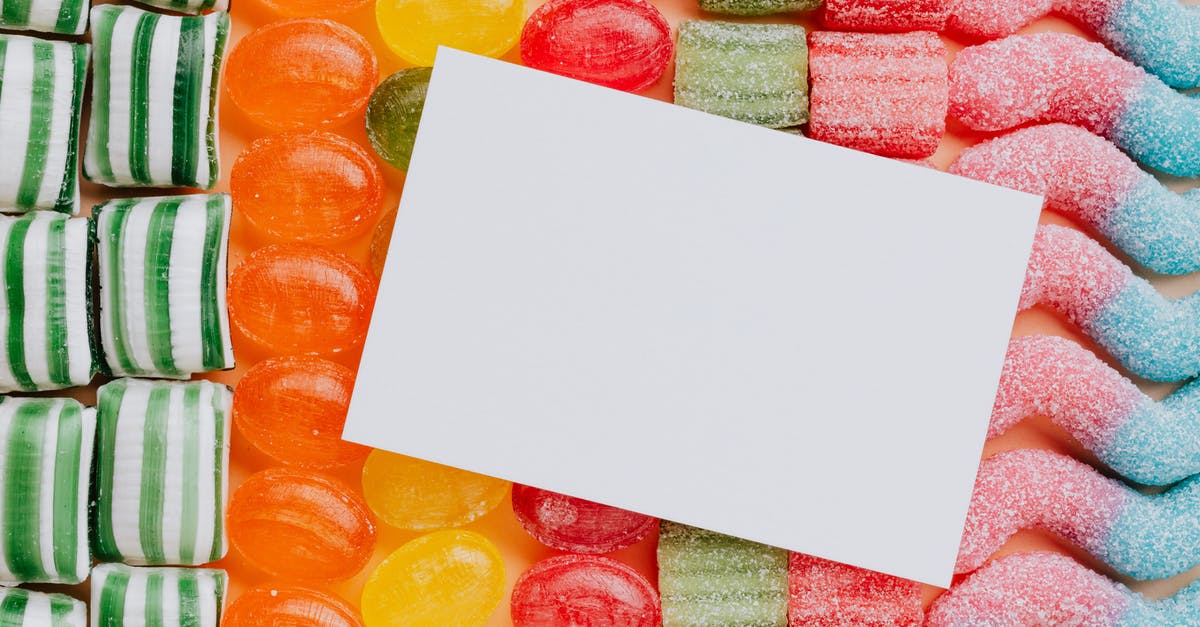 How do comedy and news shows get access to so many clips from other networks' shows? - Closeup from above of white paper card composed on rows of delicious caramel gummy jelly sweets in modern candy shop